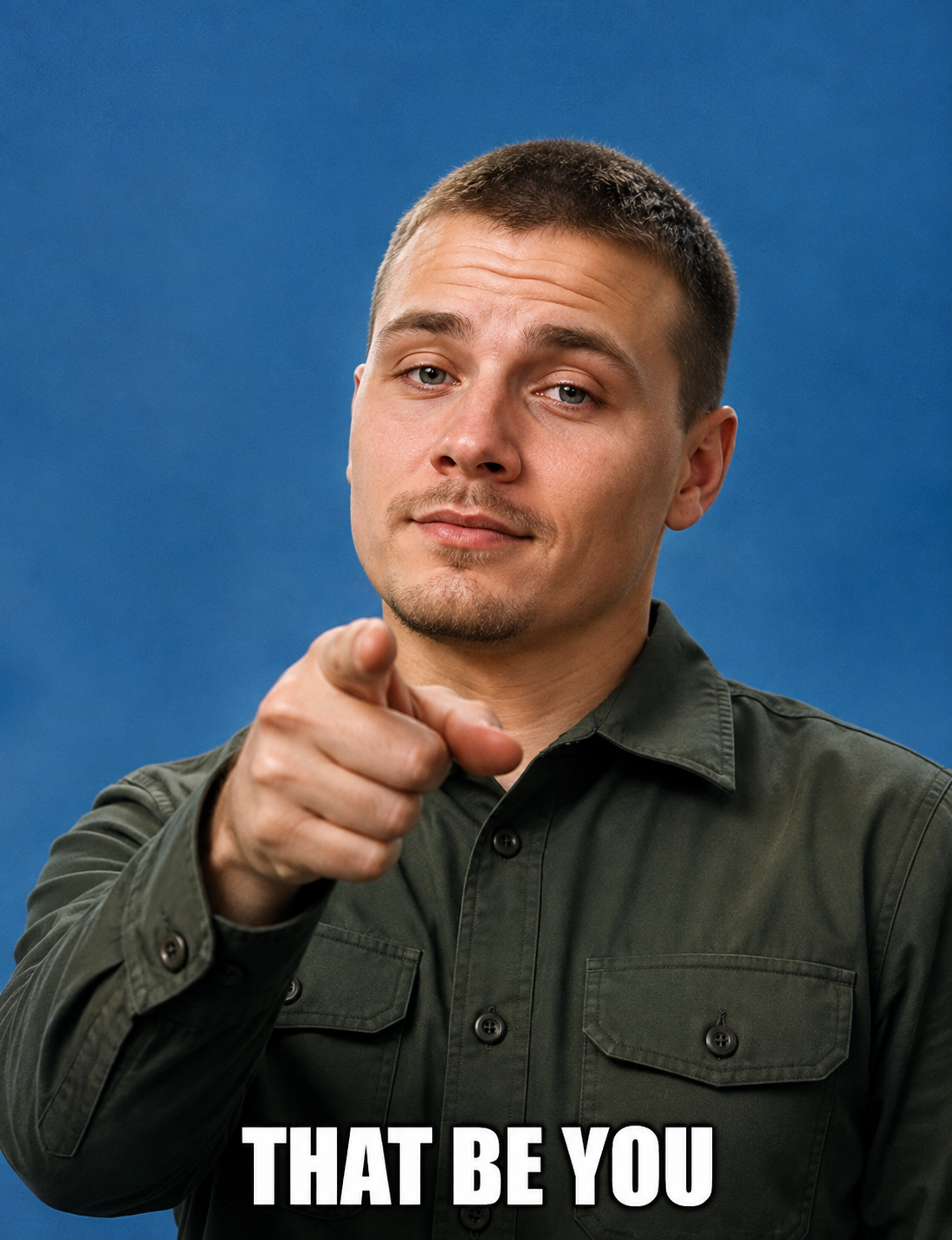 A man in a green shirt pointing directly at the camera, captioned "That be you" — calling out anyone who owns a grill and dreads what's on the brush